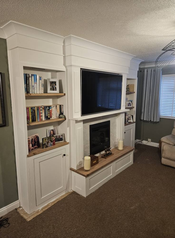 Media wall with fitted shelving and cabinets